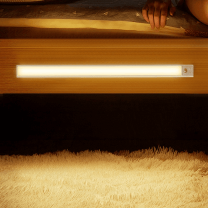 Smart LED motion sensor light with magnetic base, perfect for wardrobes, furniture, and showcases. USB rechargeable.