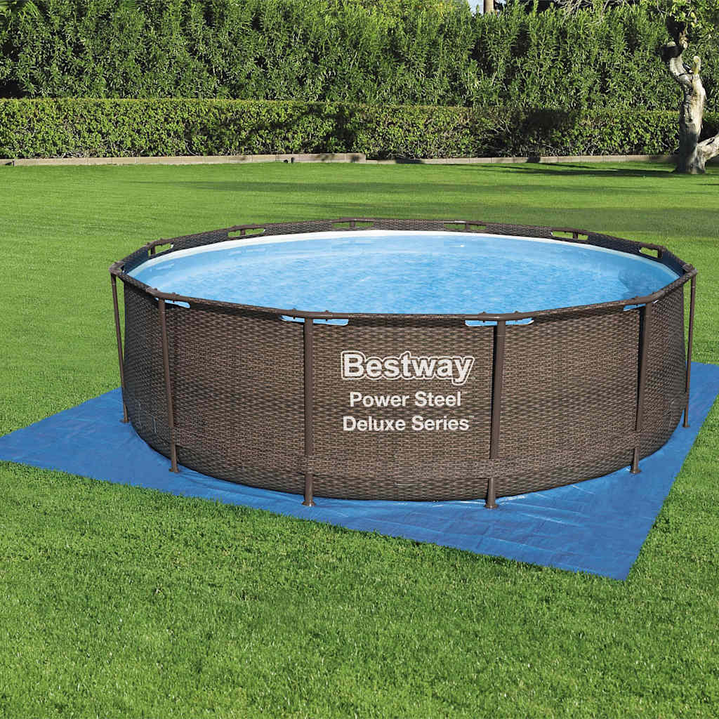 Blue Bestway Flowclear protective pool underlayment 396×396 cm laid on grass beneath an above-ground pool.