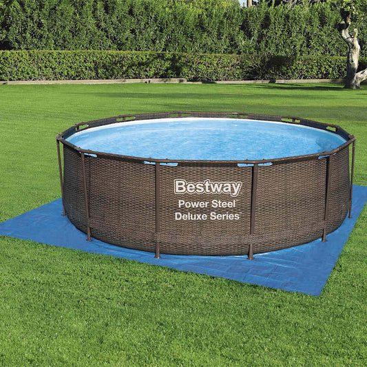 Blue Bestway Flowclear protective pool underlayment 396×396 cm laid on grass beneath an above-ground pool.