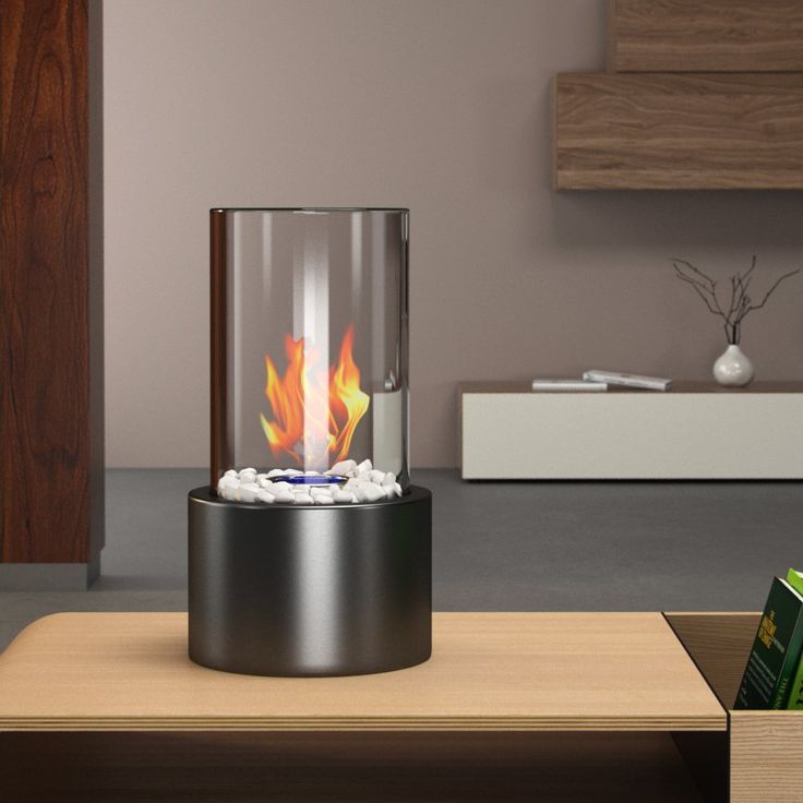 Modern stainless steel tabletop fire feature for indoor and outdoor settings.