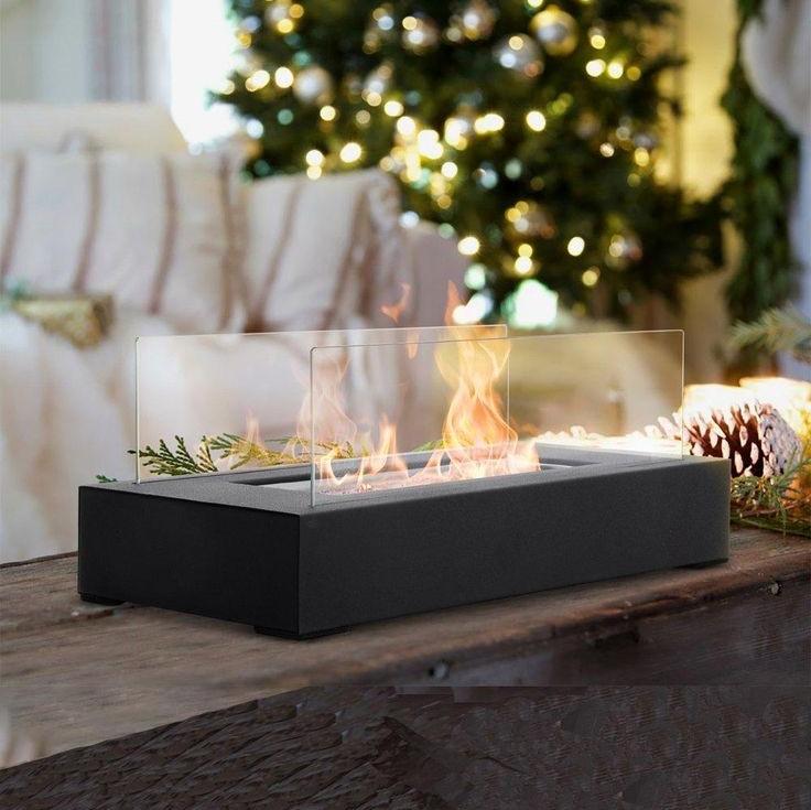 Christmas decoration ideas: Rectangular tabletop fire pit with glass wind protection.