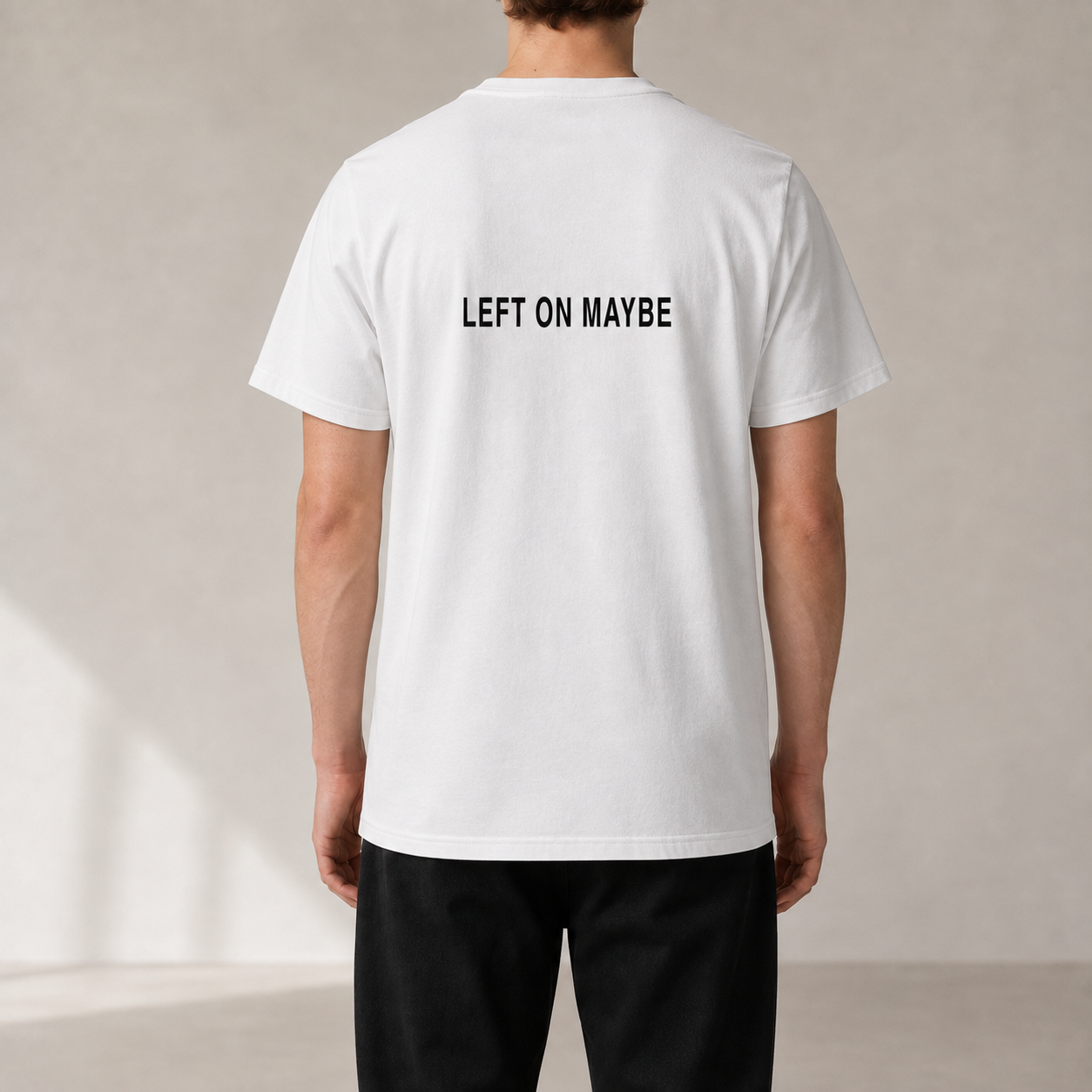 LEFT ON MAYBE White organic statement T-shirt — realistic rear view on model